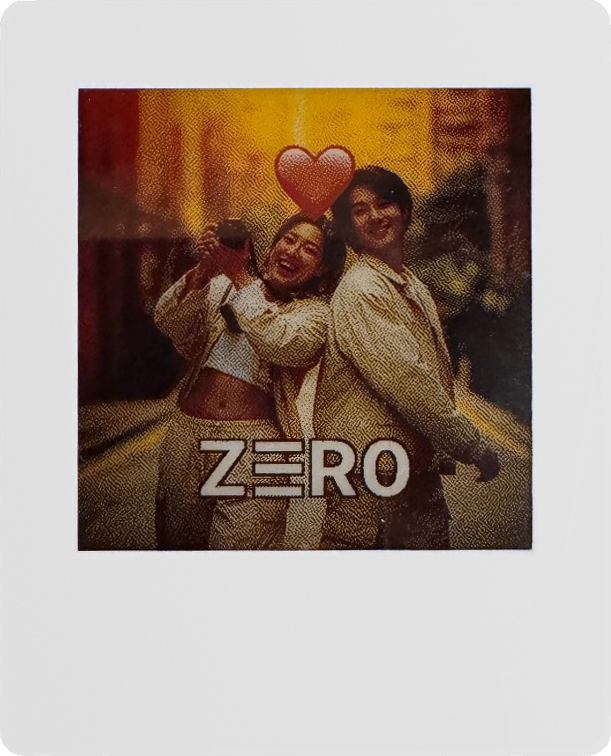 Z3R0 e-ink photo card: white-framed portrait with thick bottom chin, screen showing a couple photo with a small red heart and the Z3R0 mark.